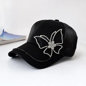 Black rhinestone butterfly decorated baseball cap with chain trim, fashionable streetwear sun hat.