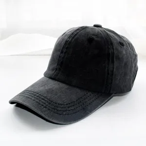 Detail shot of a classic vintage washed black denim baseball cap, casual everyday wear.