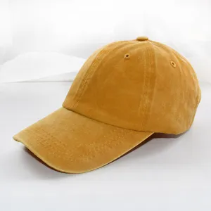 Classic washed plain casual baseball cap in yellow, detailed shot showing fabric and texture.