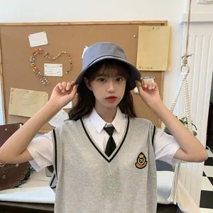 Close-up view of a stylish gray cotton bucket hat worn by a model in a casual setting