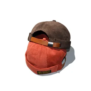 Retro corduroy brimless docker hats with adjustable leather straps in brown and orange