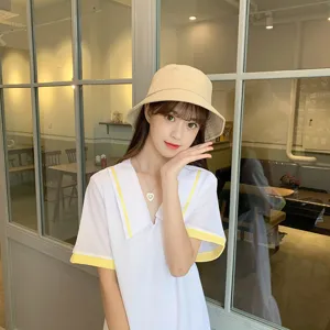 Asian woman wearing a stylish beige bucket hat in a cafe setting for sun protection.