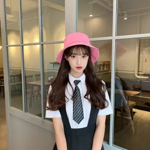 Fashionable pink bucket hat for women providing summer sun protection in a cafe setting