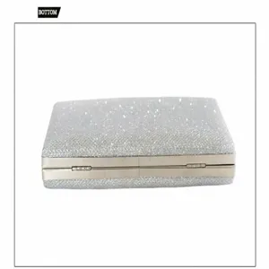 Detail view of the silver glitter evening clutch bag with metal frame and secure clasp lock.