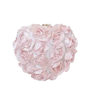 Elegant light pink heart-shaped evening clutch bag adorned with 3D satin rose flower petals