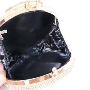 Round rhinestone evening clutch bag with gold frame and black satin lining for women parties.