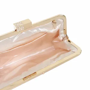 Elegant metallic frame evening clutch bag with rhinestone clasp and satin lining for party wear.
