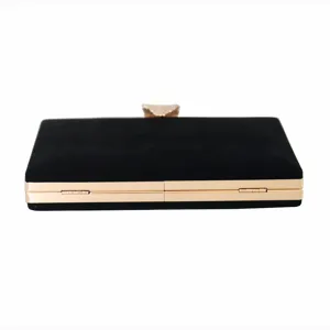 Elegant black velvet evening clutch bag featuring a decorative gold metal leaf clasp detail