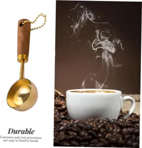 Close-up of gold-plated coffee measuring spoon with wooden handle and bead chain