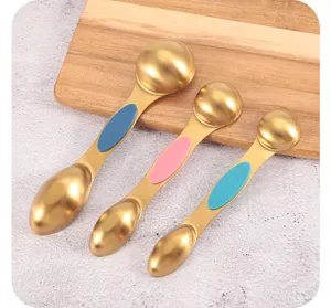 Detail view of three gold magnetic stainless steel double-headed measuring spoons