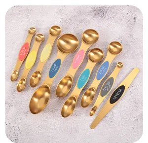Close-up of 9-piece magnetic gold stainless steel dual-sided measuring spoon set