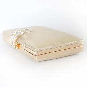 Elegant golden glitter evening clutch bag with a rhinestone clasp for parties