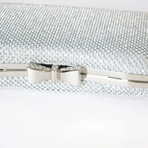 Silver rhinestone evening clutch bag with an elegant bow tie metal clasp close-up