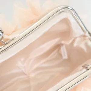 Detailed interior view of an elegant floral evening clutch with smooth champagne satin lining.