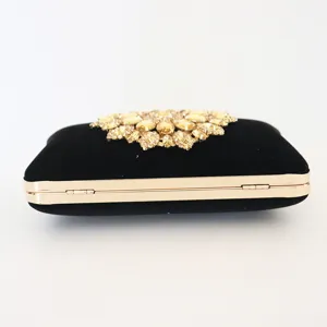 Elegant black suede clutch with golden sunflower rhinestone detail for evening events