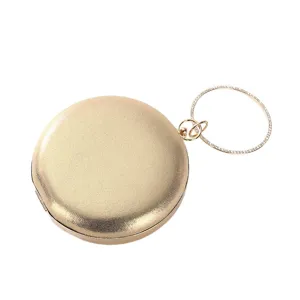Elegante bolso de noche circular dorado con un asa de anillo adornada con cristales.