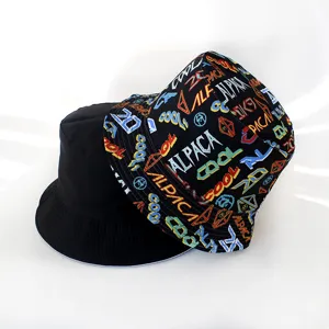 Stylish reversible bucket hat detail showing solid black side and colorful graffiti print side.