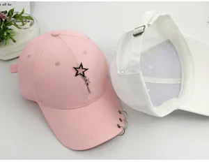 Detailed macro view of pink baseball cap with metal rings on brim and star pendant detail