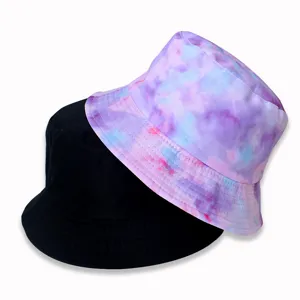 Double-sided bucket hat detail showcasing black and pastel tie-dye fabric textures clearly.