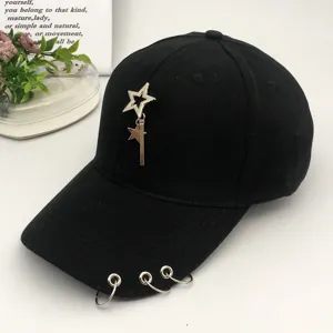 Minimalist black baseball cap featuring a metal star pendant and three iron rings on brim