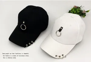 Unisex punk style baseball cap featuring metal ring pendant and brim piercing details.