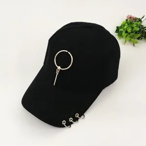 Black punk style baseball cap with metal rings and piercing pendant, cool street fashion hat.