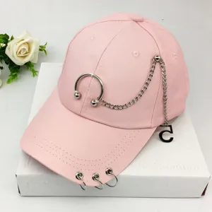 Trendy pink baseball cap with decorative metal chains and punk style rings for women
