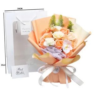 Artificial soap flower bouquet in orange and white with gift bag and greeting card included.