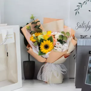 Macro view of an artificial sunflower bouquet with elegant white lace ribbon detail.
