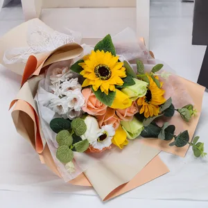 Detailed macro view showing artificial sunflower and rose bouquet with delicate lace