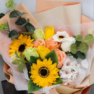 Close-up of artificial flower bouquet with sunflowers, roses, and eucalyptus leaves
