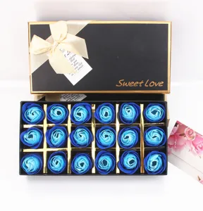 Cadeaubox met 18 blauwe zeeprozen in een elegante zwarte en gouden strikverpakking