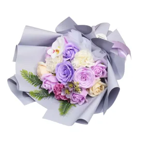 Artificial soap rose and carnation flower bouquet wrapped in grey paper for romantic gifts.