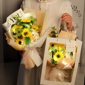 Artificial sunflower bouquet with LED fairy lights in elegant gift bag and packaging.