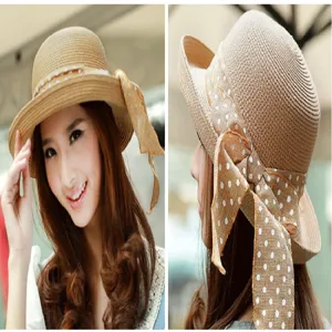 Elegant women's wide brim straw sun hat with a polka dot ribbon bow for beach vacation