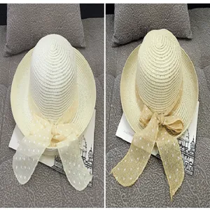 Detail view comparing white and beige summer straw sun hats featuring elegant polka dot bows
