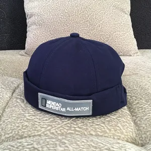 Classic navy blue docker cap with front text patch, stylish retro hip-hop streetwear hat.