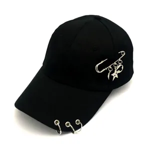Trendy black baseball cap featuring metal rings on brim and safety pin charm with stars