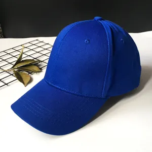 Solid royal blue cotton baseball cap detail showing fabric texture and stitched brim