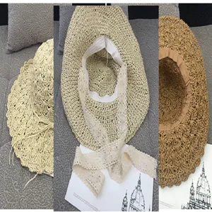 Macro detail of women's summer woven straw sun hat with elegant lace ties and wide brim