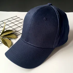 Detailed view of a navy blue cotton baseball cap with a structured crown and curved brim
