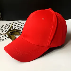 Detailed view of a vibrant red cotton baseball cap with a classic curved brim design