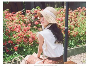 Elegant women's straw sun hat with white lace ribbon for summer beach vacation detail