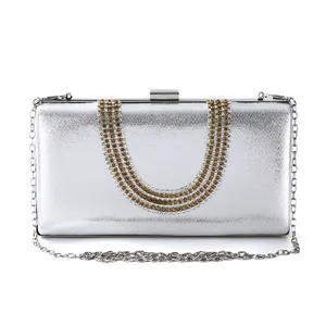 Elegant silver evening clutch bag with sparkling rhinestones and chain strap for women.