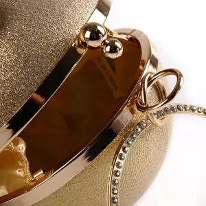 Elegant gold spherical evening clutch bag with glitter finish and sparkling rhinestones