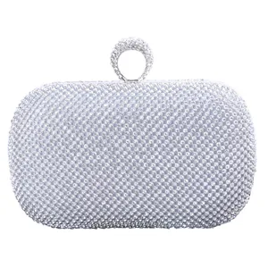 Elegant rhinestone evening clutch bag with sparkling crystals and chic circular ring top handle.
