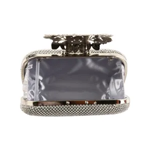 Silver rhinestone evening clutch bag with ornate metal flower leaf clasp