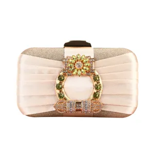 Elegant champagne pleated evening clutch bag with large green rhinestone flower clasp