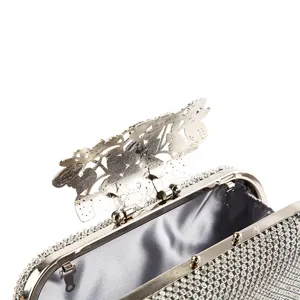 Silver rhinestone evening clutch bag with ornate flower and leaf filigree clasp