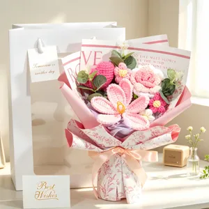 Detailed macro view of a handmade pink crochet flower bouquet with gift bag and cards